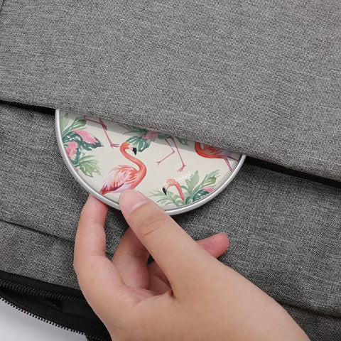 Person placing 10W Fast Wireless Charger Pad For iPhone And Android with flamingo design into gray bag pocket