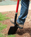 Person using Round Point Digging Shovel With D Handle, 31 Inch Fiberglass Shaft in yard work on loose soil and rocks