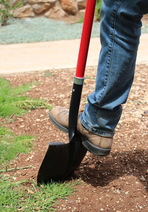 Person using Round Point Digging Shovel With D Handle, 31 Inch Fiberglass Shaft in yard work on loose soil and rocks