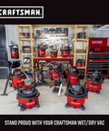 Multiple Craftsman wet/dry vacuums displayed in a workshop setting with organized shelving and tools in the background.