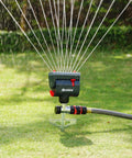 4-Way Adjustable Mini Turbo Oscillating Sprinkler With Step Spike Gear Drive for heavy-duty lawn watering system in use