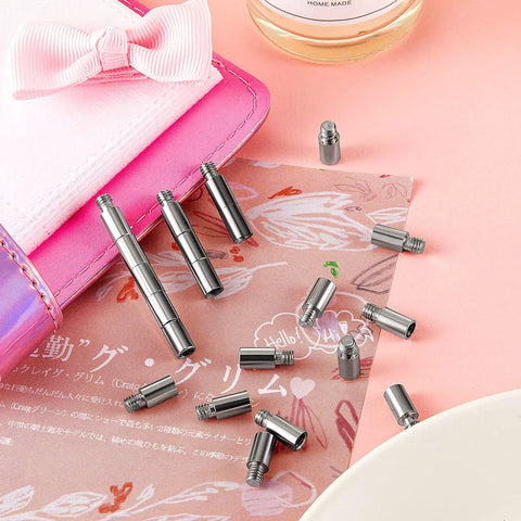 Rock Solid 40 Piece Scrapbook Extension Posts And Screws To Keep Post Bound Album Pages Locked Tight And Looking Fresh Durable Binding Hardware For Photographers And Makers with silver posts on decorative paper.