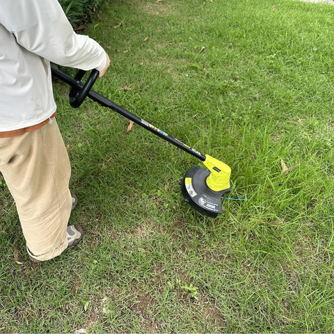 Person using No Fuss Replacement Bladed Head With Spool Line For Ryobi 18V 24V 40V Weed Eater Trimmers Fits RY40210 RY40210A on grass