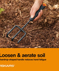 Hand using cultivator from Three Piece Garden Tool Set With Trowel Transplanter And Cultivator Durable Rust Resistant Steel Heads And Ergonomic Handles For Planting Digging And Soil Aeration No Fuss Yard Work in soil