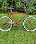 Red bicycle with 26 Inch Cruiser Bike Tire Replacement Set With Two Tubes And Levers, white sidewall tires, parked on grass