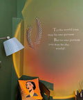 Sunset Projection Lamp With 180 Degree Rotation LED Night Light For Photography And Selfies casting light on green wall decor