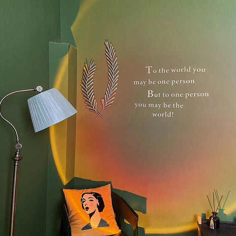 Sunset Projection Lamp With 180 Degree Rotation LED Night Light For Photography And Selfies casting light on green wall decor