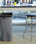 Office setting with a tall trash can lined with 44 to 55 Gallon Trash Bags, 200 Count, Tough As Nails Clear Liners That Conform To Brute 44G.