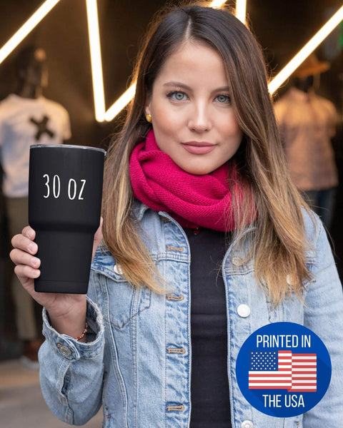 Woman holding huge 30 oz vacuum insulated tumbler with lid keeps hot drinks hot and cold drinks cold all day black stainless steel cup