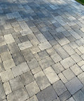 Rock Solid Penetrating Concrete Sealer 5 Gallon Solvent Based Wet Look Finish Color Enhancer Stain Guard For Stamped Concrete And Brick Pavers showing textured paver patio surface.