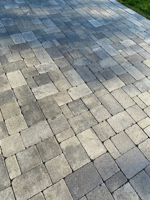 Rock Solid Penetrating Concrete Sealer 5 Gallon Solvent Based Wet Look Finish Color Enhancer Stain Guard For Stamped Concrete And Brick Pavers showing textured paver patio surface.
