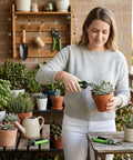 Woman using Two Pack 8 Inch Bypass Garden Pruning Shears And 6.25 Inch Advanced Garden Scissors Set on potted plants