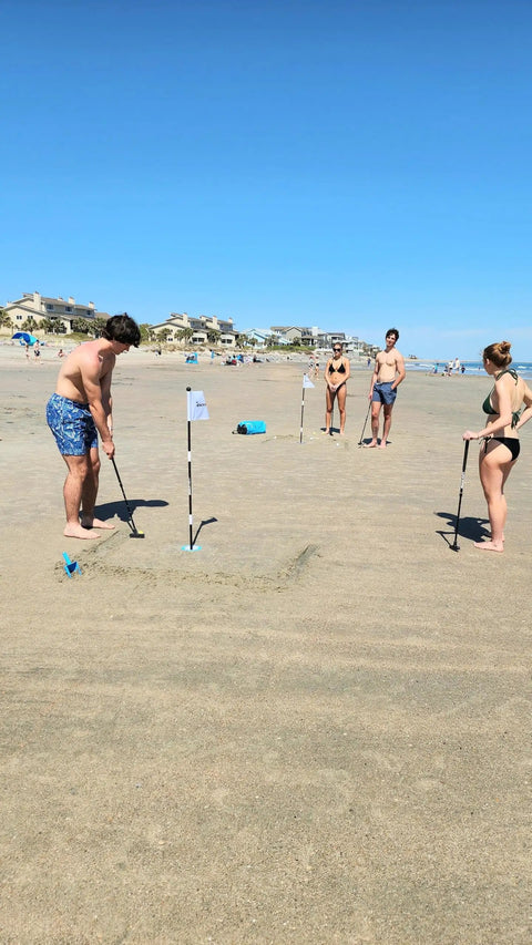 Family playing with Beach Side Golf Set For The Sand With Two Adjustable Putters Waterproof Dry Bag Flags Cups on beach