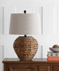 Natural Water Hyacinth Farmhouse Basket Table Lamp 24.5 Inch With Light Gray Linen Shade on wooden nightstand