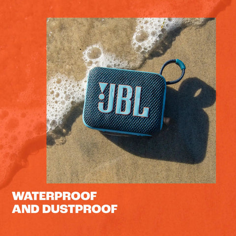Go 4 Ultra Portable Bluetooth Speaker That Goes Anywhere With Waterproof And Dustproof Build, blue, on sandy beach close-up.