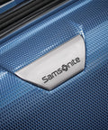 Close-up of Samsonite logo on scratch-resistant honeycomb exterior of Lightweight 3-Piece Polycarbonate Spinner Suitcase Set in Lagoon