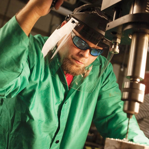 Person wearing Hellraiser Safety Glasses with Light Blue Lenses and Black Frame, UV 99.9% Protection during indoor machining work.