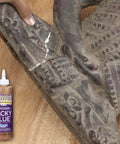Person using All Purpose Tacky Glue 8 Ounce Clear Non Toxic Dries Clear And Flexible Great For Fabric Silk Burlap Paper Trimming And Decor Easy Clean Up With Water DIY Friendly Perfect For Crafts to bond a broken statue on wooden surface.