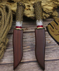 Damascus Steel Hunting Knife With Faux Antler Handle, 5.4 Inch Fixed Blade Skinner with wooden sheath on rustic wood background