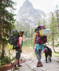 Two hikers with Z Lite Original Camping And Backpacking Sleeping Pad Lightweight Closed Cell Foam Ground Pad in the forest