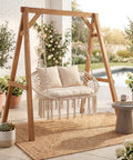 Double Hammock Chair With Cushions For Indoor And Outdoor Hangouts Boho Macrame Swing Seat That Fits Two People Patio Balcony Porch Supports Up To 600 Lbs Cozy Beige displayed on a patio with plants