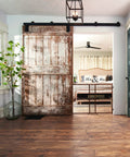 Farmhouse room with wooden floor and rustic sliding door, showcasing Position And Lock Tall And Wide Adjustable Baby Gate For Doorways 31 To 50 Inches Wide And 32 Inches Tall Easy One Hand Latch Kid Friendly Farmhouse Collection Safe Gate For Nurseries Stairs And Play Areas in nursery setting.