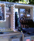 Rugged Polycarbonate Enclosure With Hinged Locking Clear Cover 24 X 24 X 10 Inches IP68 NEMA 4X Non-Metallic Control Box open next to a laptop