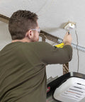 Man installing Heavy Duty Garage Door Opener Surge Protector For Single Opener With 15A 125VAC 1875W UL Listed Protection to outlet