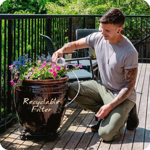 Person using Replacement Alkaline Water Filter For At Home Pitcher With Mineral Boost to water plants on a patio.
