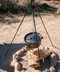 Rugged Heavy Duty Steel Camping Tripod For Open Fire Cooking 43.3 Inch Tall with Dutch oven over campfire in desert setting.