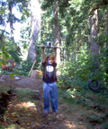 Child using Backyard Zip Line Kit With 200 Feet Of Galvanized Cable And Aluminum Trolley For Epic Backyard Thrills Heavy Duty