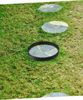 Round Concrete Paver Mold For DIY Garden Paths And Patios placed on grass, showing its use for creating stone walkways.