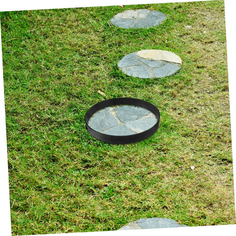 Round Concrete Paver Mold For DIY Garden Paths And Patios placed on grass, showing its use for creating stone walkways.