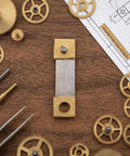 Old School Pendulum Suspension Spring Replacement Kit for Vintage Grandfather Clocks with gears on wooden surface