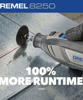 Dremel 8250 cordless rotary tool with grinding disc on metal surface, blue/gray body, gloved hand