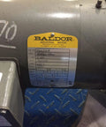 Close-up of a Baldor brake motor label showing VBM3554T model, 1.50 HP, 1800 RPM, 208-230/460V three-phase TEFC industrial motor