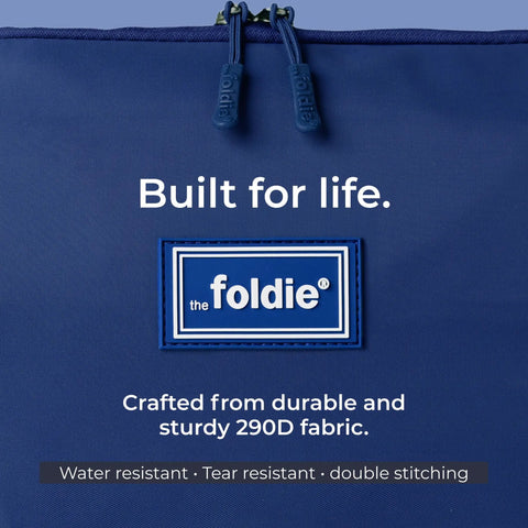 Close-up of Foldable Travel Tote Bag For Women, 40L Weekender Duffel in navy blue, showing durable 290D fabric and logo patch.