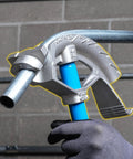 Ideal Electrical 74-032 Aluminum Bender Head For 3/4 Inch Conduit Pipe holding a metal pipe indoors.