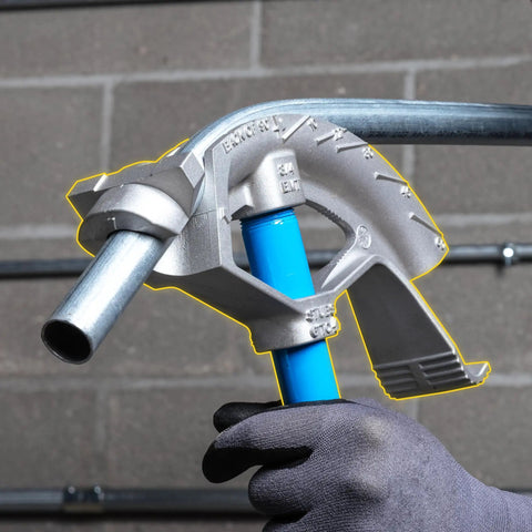 Ideal Electrical 74-032 Aluminum Bender Head For 3/4 Inch Conduit Pipe holding a metal pipe indoors.