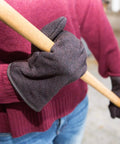 Person wearing Brown Jersey Winter Work Gloves with Red Fleece Lining holding a tool
