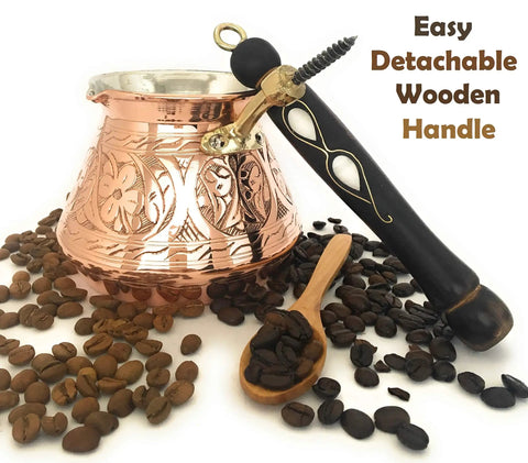 Dope Thick Solid Copper Turkish Greek Arabic Coffee Pot With Wooden Handle For Stovetop Brewing Jazzve Cezve Ibrik Briki Café Turco Large 18 Oz Engraved Design Authentic Turkish Coffee Maker surrounded by coffee beans.
