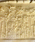 Mini Embossed Rolling Pin Set Of 3 With Bees, Meadow And Forest Patterns imprint on cookie dough.