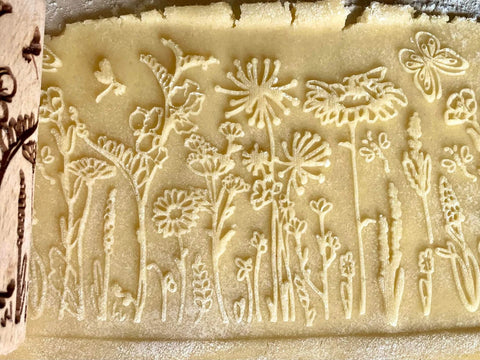 Mini Embossed Rolling Pin Set Of 3 With Bees, Meadow And Forest Patterns imprint on cookie dough.