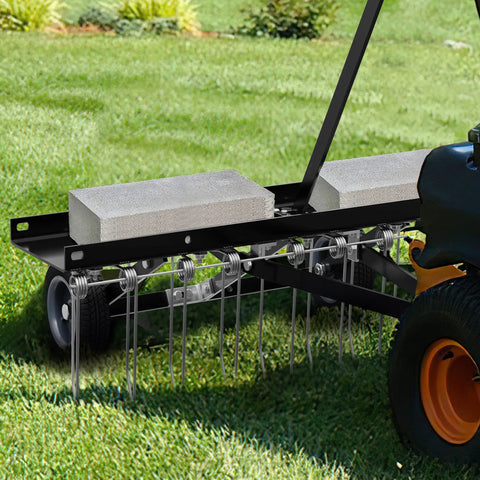Tow Behind Dethatcher Powerful 40 Inch With 20 Spring Steel Tines attached to a tractor, showing lift handle and weight blocks on grass.