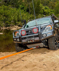 4x4 vehicle using RK12A Weekender Recovery Offroad Kit with 17500 lb snatch strap to get unstuck from sand near river.