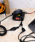 UV 25X4 Second Gen Mini Mobile 25 Watt Tri Band Base Station Radio with antenna and cables connected to a laptop