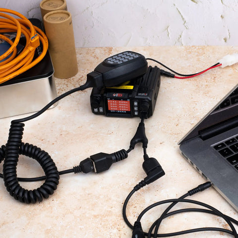 UV 25X4 Second Gen Mini Mobile 25 Watt Tri Band Base Station Radio with antenna and cables connected to a laptop