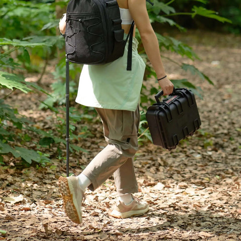Kickass Hard Camera Case Featuring Smooth Side Handles And Custom Foam Dividers For Dslr Gear Transport being carried in the woods.