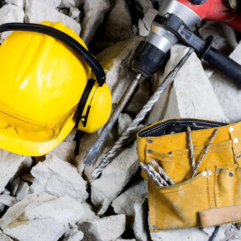 SOMADA 1-in x 39-in SDS Plus long drill bit with carbide tip, shown with yellow hard hat and tool belt amid concrete rubble