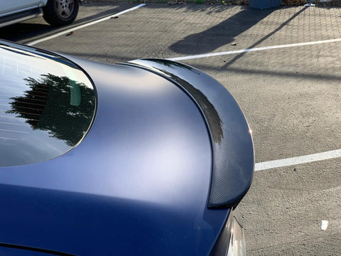Real Molded Carbon Fiber Matte Dry Look Spoiler For Tesla Model 3 viewed from above showing sleek aerodynamic design.